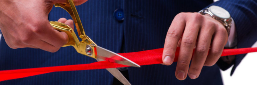 Event Marketing Page Header Images shows male hands cutting a red ribbon with scissors